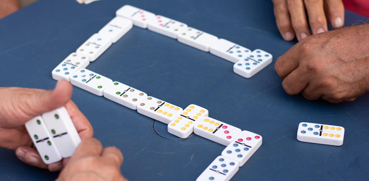 two players playing mexicain train dominoes